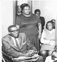 Evelyn T. Butts (standing) Her attorney Joseph Jordan (seated)